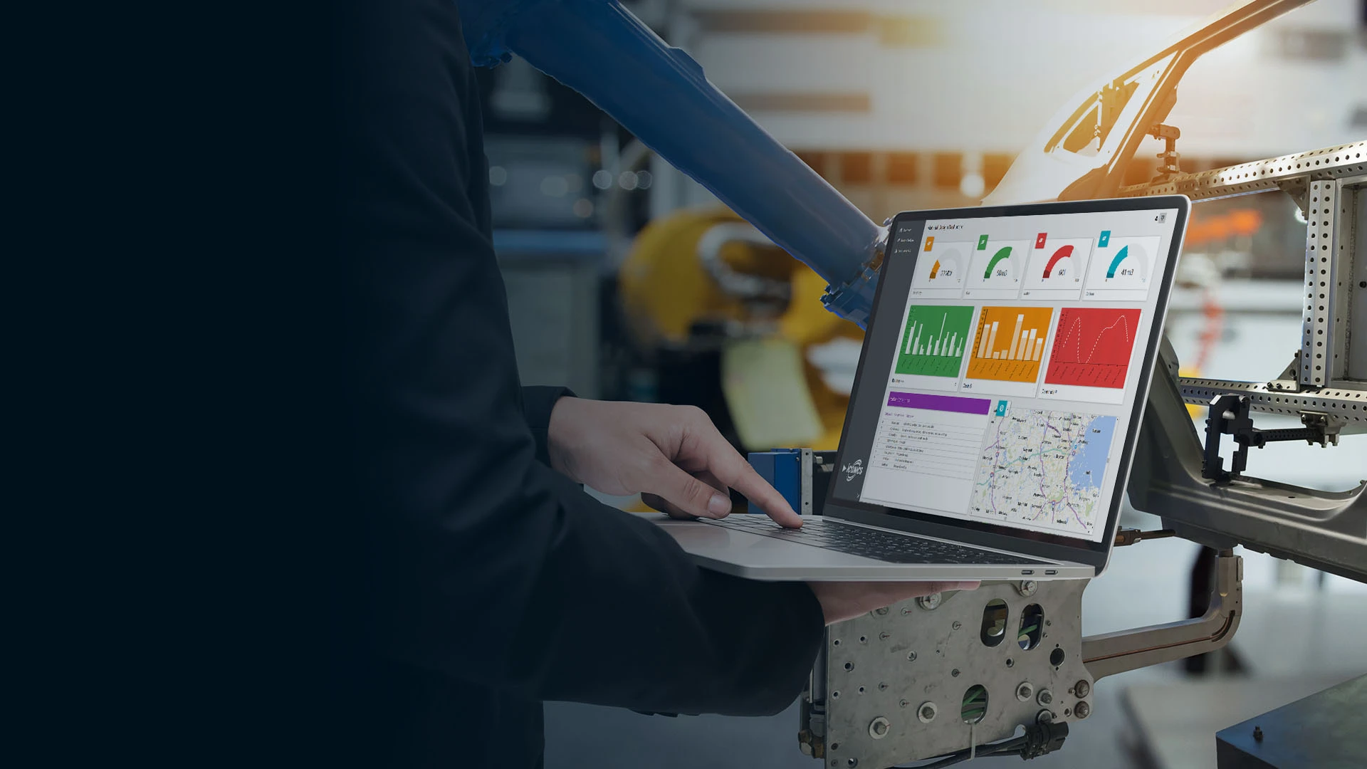 SCADA solutions page banner of person holding laptop with various dashboard views visible on screen